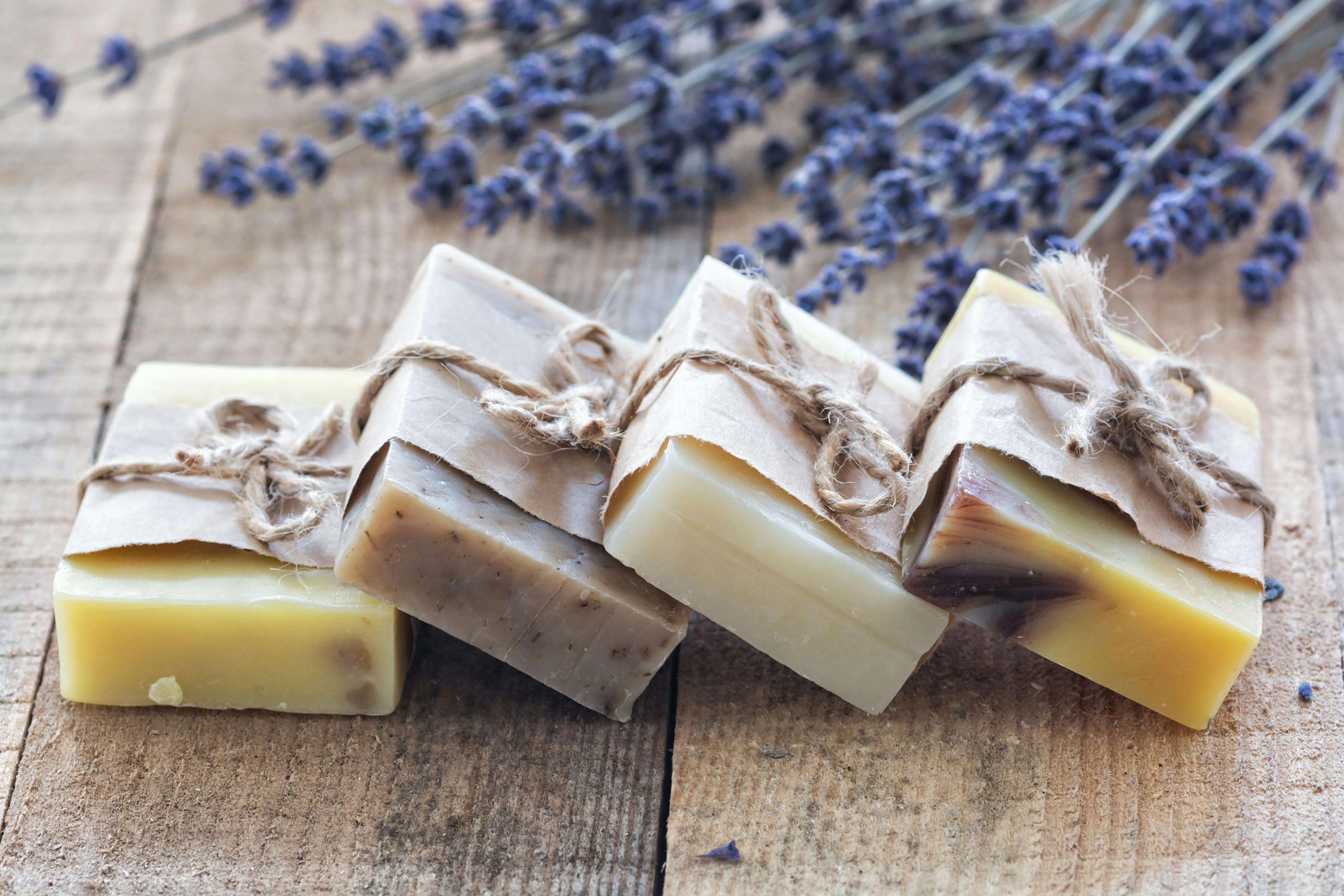 Four wrapped handmade soap bars with dried lavender